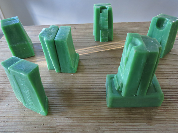 Sunlight Carved soap objects 6 x 9 cm on wooden washboard.